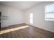 Bright dining area features wood-look flooring, crisp white walls, a window, and an exterior door at 132 Velvet Hat Rd, Danville, IN 46122