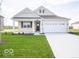 Charming single-story home with a well-maintained lawn, attached two car garage, and a covered front porch at 132 Velvet Hat Rd, Danville, IN 46122
