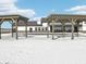 Exterior with a pergola showing a white home with black trim and snow-covered ground at 132 Velvet Hat Rd, Danville, IN 46122