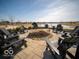 Inviting fire pit area with Adirondack chairs and a scenic lake view, perfect for relaxing evenings outdoors at 132 Velvet Hat Rd, Danville, IN 46122
