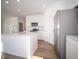Modern kitchen with white cabinets, stainless steel appliances, and a center island with quartz countertops at 132 Velvet Hat Rd, Danville, IN 46122