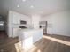 Bright, modern kitchen with stainless steel appliances, a large island, and white cabinets at 132 Velvet Hat Rd, Danville, IN 46122