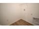 Bright laundry room featuring hardwood floors, white walls, and a wire shelf for optimal storage solutions at 132 Velvet Hat Rd, Danville, IN 46122
