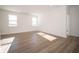 Bright and airy living room featuring hardwood floors, crisp white walls, and large windows at 132 Velvet Hat Rd, Danville, IN 46122