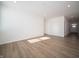 Bright open living area featuring hardwood floors and crisp white walls leading to the front door at 132 Velvet Hat Rd, Danville, IN 46122