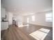 Open-concept living space with wood floors, white walls, stainless appliances, and bright natural light at 132 Velvet Hat Rd, Danville, IN 46122