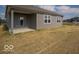 Exterior view of home featuring neutral siding, multiple windows, and a covered patio area for outdoor enjoyment at 120 Velvet Hat Rd, Danville, IN 46122