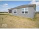 Exterior view of the home showcasing the neutral siding and a small covered patio space at 120 Velvet Hat Rd, Danville, IN 46122