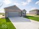 A charming single-story home featuring a two-car garage, a long driveway, and a well-maintained lawn at 120 Velvet Hat Rd, Danville, IN 46122