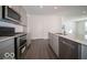 Modern kitchen features stainless steel appliances, ample cabinetry, and an island with a sink at 120 Velvet Hat Rd, Danville, IN 46122