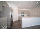 Modern kitchen features a stainless steel refrigerator, gray cabinets, and a central kitchen island at 120 Velvet Hat Rd, Danville, IN 46122