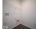 A laundry room includes wood-style flooring with a wire rack and connections for a washer and dryer at 120 Velvet Hat Rd, Danville, IN 46122