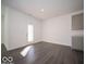 Empty living room that features white walls and an exit to the backyard at 120 Velvet Hat Rd, Danville, IN 46122