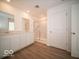 Modern bathroom with double vanity, glass shower, and wood-look floors at 126 Velvet Hat Rd, Danville, IN 46122