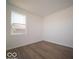 Cozy bedroom with wood-look floors, bright white walls and a window providing natural light at 126 Velvet Hat Rd, Danville, IN 46122