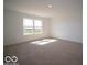 A bright bedroom featuring neutral carpet and large windows for ample natural light at 126 Velvet Hat Rd, Danville, IN 46122