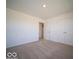 Bedroom with neutral carpet, double door closet, and a view into the hallway at 126 Velvet Hat Rd, Danville, IN 46122