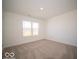 A simple bedroom with neutral carpet flooring and a single window with a view of the outside at 126 Velvet Hat Rd, Danville, IN 46122