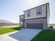 Angle view of a two-story home with a two-car garage and nice lawn, under a clear sky at 126 Velvet Hat Rd, Danville, IN 46122