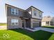 Charming two-story home with a brick and siding exterior, gray garage door, and landscaped front yard at 126 Velvet Hat Rd, Danville, IN 46122