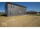 Rear exterior view of a two story home with gray siding and a small concrete patio at 126 Velvet Hat Rd, Danville, IN 46122
