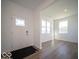 Bright foyer with wood-look floors, a decorative front door, and a view into the adjacent room with windows at 126 Velvet Hat Rd, Danville, IN 46122