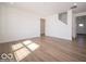 Bright living room featuring hardwood floors and fresh white walls at 126 Velvet Hat Rd, Danville, IN 46122