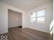 Inviting living room with bright white walls, wood-look flooring, and large windows providing ample natural light at 126 Velvet Hat Rd, Danville, IN 46122