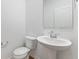 Clean half bathroom with a pedestal sink and modern fixtures at 243 Hunters Ridge Dr, Danville, IN 46122