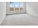Bright bedroom featuring three large windows and neutral carpeting at 243 Hunters Ridge Dr, Danville, IN 46122