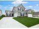 Charming two-story home featuring a manicured lawn, gray siding, black shutters, and a spacious two-car garage at 243 Hunters Ridge Dr, Danville, IN 46122