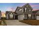 New two-story home with gray siding, dark shutters and a two-car garage at 243 Hunters Ridge Dr, Danville, IN 46122