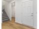 Inviting foyer featuring hardwood floors, an entry door, staircase, and access to other areas of the home at 243 Hunters Ridge Dr, Danville, IN 46122