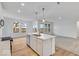 Modern kitchen with island, stainless steel appliances, hardwood floors and natural lighting at 243 Hunters Ridge Dr, Danville, IN 46122