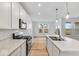 Contemporary kitchen boasts stainless steel appliances, marble countertops, and a functional sink arrangement at 243 Hunters Ridge Dr, Danville, IN 46122