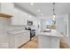 Bright kitchen featuring stainless steel appliances, white cabinets, and a functional island for cooking at 243 Hunters Ridge Dr, Danville, IN 46122