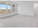 Bright living room with plush carpeting and large windows providing plenty of natural light at 243 Hunters Ridge Dr, Danville, IN 46122