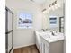Bathroom with double vanity, large mirror, and frameless shower at 7098 Sterling Way, Brownsburg, IN 46112