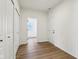 Clean and simple hallway with hardwood floors and white doors at 7098 Sterling Way, Brownsburg, IN 46112