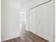 Bright hallway with white doors and hardwood floors at 7098 Sterling Way, Brownsburg, IN 46112