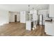 Bright kitchen with island, stainless steel appliances, and hardwood floors at 7098 Sterling Way, Brownsburg, IN 46112