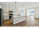 Modern kitchen features island, stainless steel appliances, and light-colored cabinetry at 7098 Sterling Way, Brownsburg, IN 46112