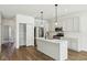 Modern kitchen with white cabinets, an island, and stainless steel appliances at 7098 Sterling Way, Brownsburg, IN 46112