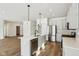 Modern kitchen boasts island, stainless steel appliances, and hardwood floors at 7098 Sterling Way, Brownsburg, IN 46112