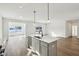 Open concept kitchen with island, stainless steel appliances, and hardwood floors at 7098 Sterling Way, Brownsburg, IN 46112