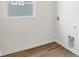 Laundry room with vinyl flooring, window, and hook ups at 7098 Sterling Way, Brownsburg, IN 46112