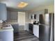 Updated kitchen featuring stainless steel appliances, gray cabinets, and luxury vinyl plank flooring at 7530 Redcliff Rd, Indianapolis, IN 46256