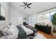 Cozy bedroom with a ceiling fan, a plush rug, and French doors to the exterior at 1423 Hoyt Ave, Indianapolis, IN 46203