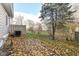 Backyard patio covered in autumn leaves at 383 Carmelaire Ct, Carmel, IN 46032