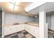 Basement wet bar with white cabinets and checkered flooring at 383 Carmelaire Ct, Carmel, IN 46032